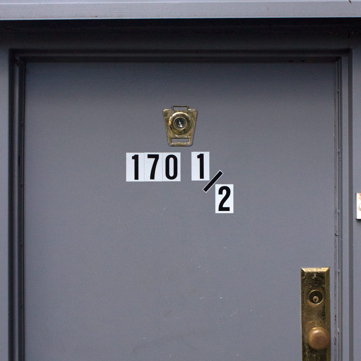Street address ‘170 and a half’ placed on a door using the same-size numbers for the whole numbers as for the half-numbers