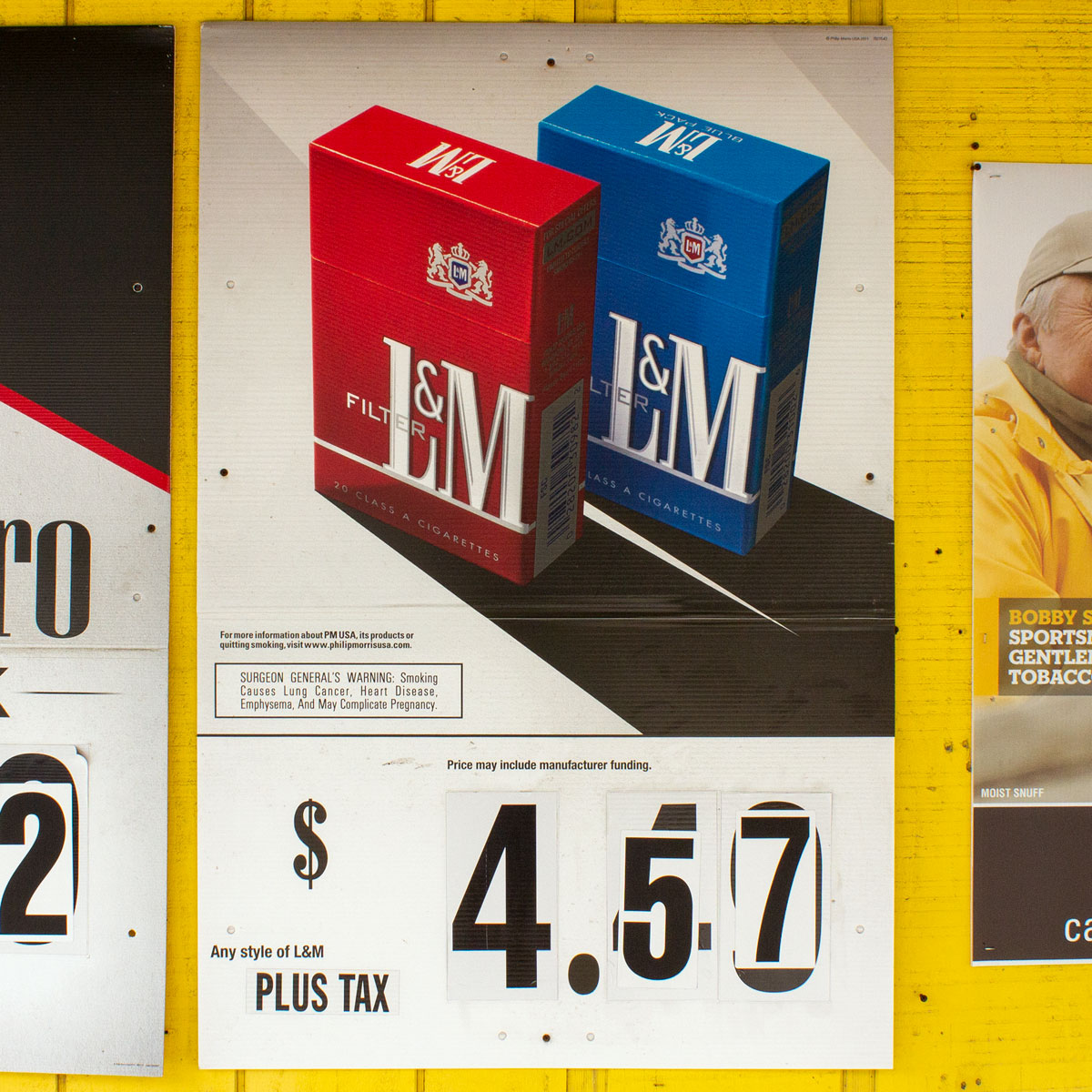 Cigarette advertisement where numbers indicating price have been pasted over with new numbers