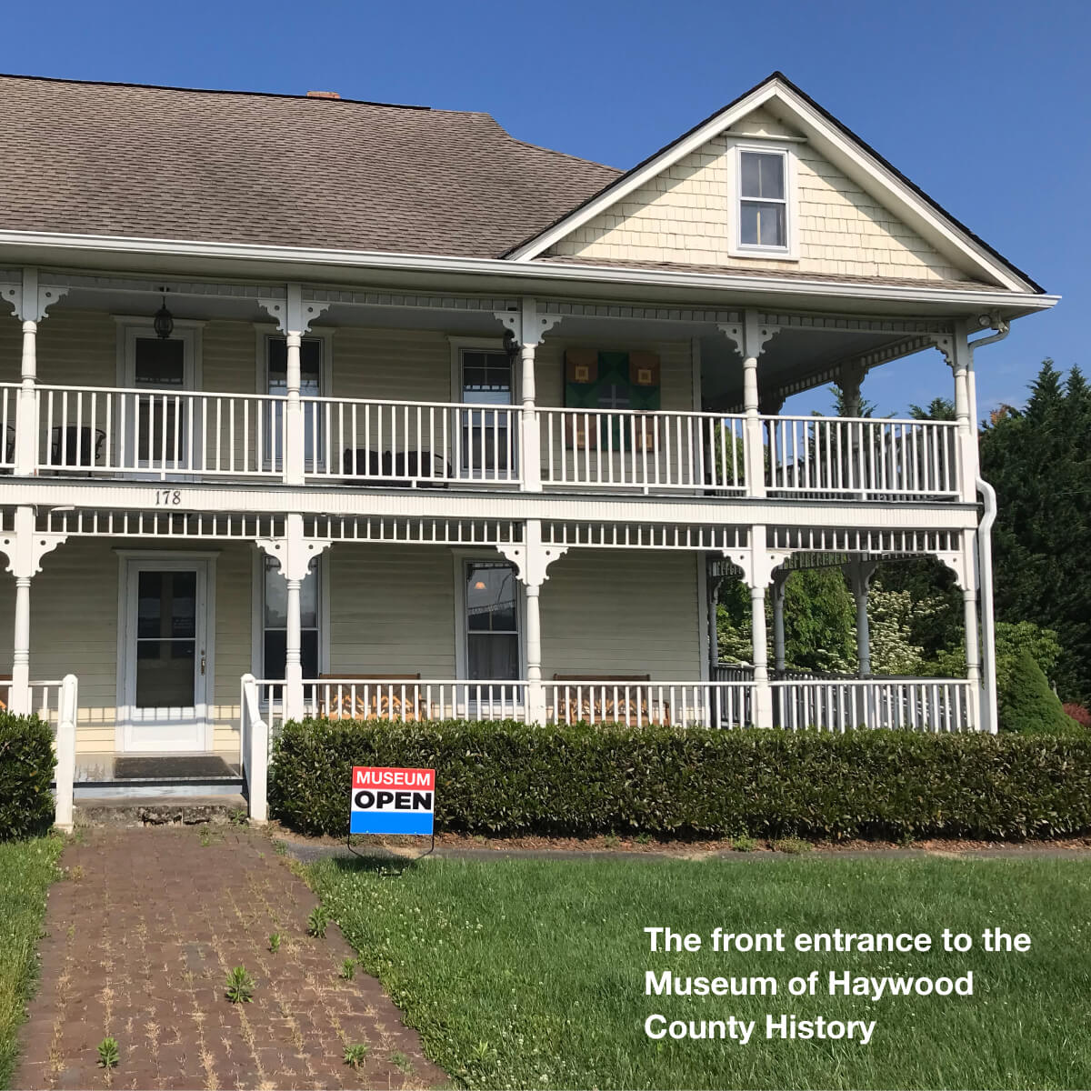 Photo of the front of the Museum of Haywood County History, which is a white two story house with wrap-around porch